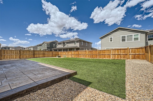 view of yard with a patio, a residential view, and a fenced backyard