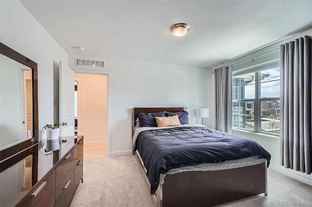 bedroom featuring light colored carpet and visible vents