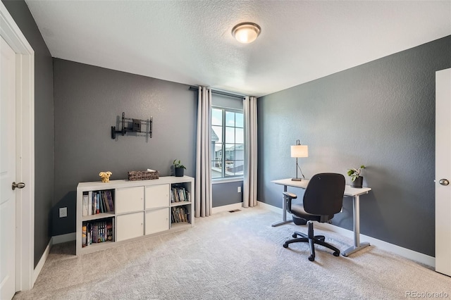 carpeted home office featuring baseboards, a textured ceiling, and a textured wall