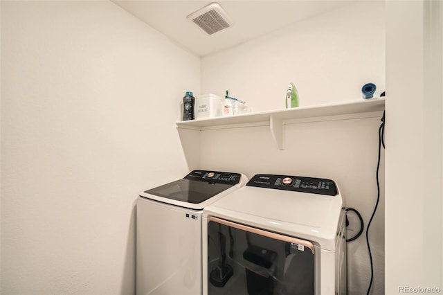 laundry room featuring laundry area, independent washer and dryer, and visible vents