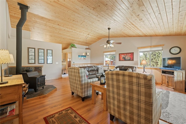 1948 Wagon Wheel Rd, Hartsel, CO 80449 - living area with a wood stove, wood ceiling, a ceiling fan, vaulted ceiling, and light wood-style floors