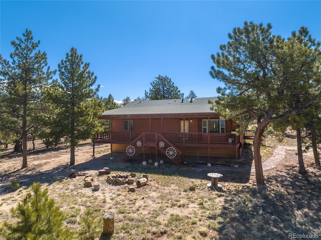 1948 Wagon Wheel Rd, Hartsel, CO 80449 - rear view of house featuring a wooden deck, an outdoor fire pit, and log veneer siding