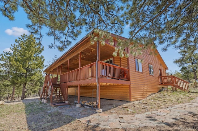 1948 Wagon Wheel Rd, Hartsel, CO 80449 - view of property exterior featuring stairs, log veneer siding, and a deck