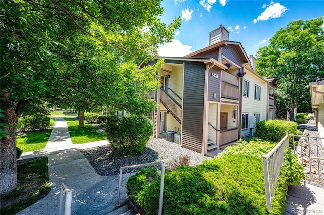 5439 S Dover St Unit 101, Littleton, CO 80123 - view of side of property with a chimney
