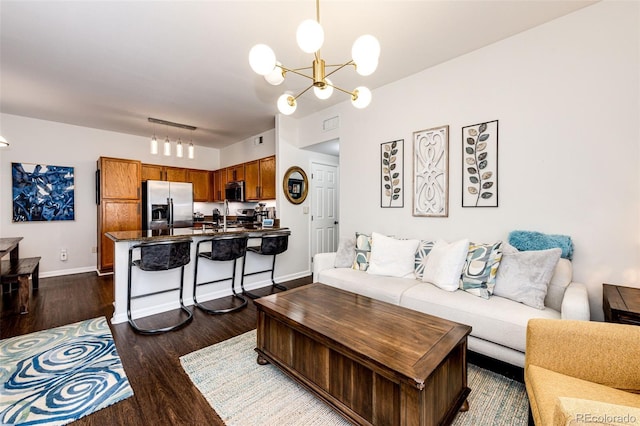 5439 S Dover St Unit 101, Littleton, CO 80123 - living area featuring dark wood finished floors and a chandelier