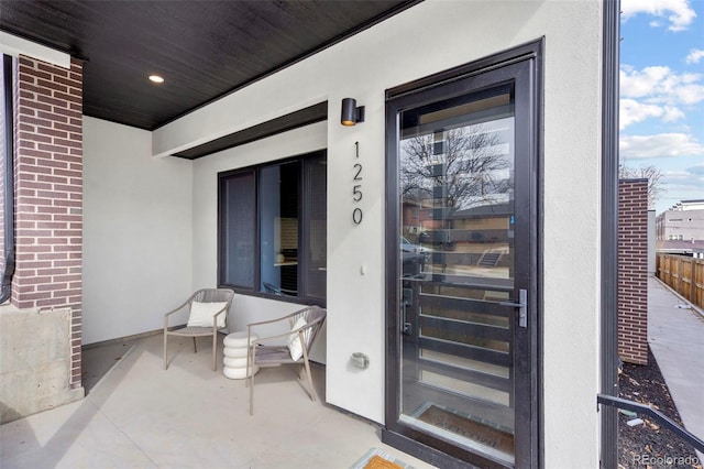 1250 Yates St, Denver, CO 80204 - view of exterior entry featuring stucco siding and brick siding
