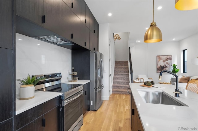 1250 Yates St, Denver, CO 80204 - kitchen with stainless steel appliances, light wood finished floors, under cabinet range hood, light countertops, and recessed lighting