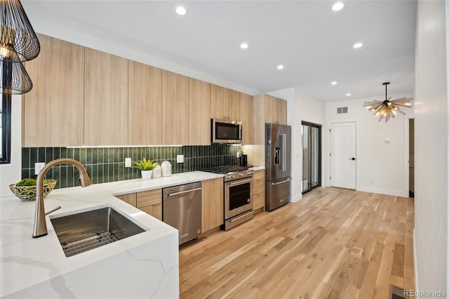 1735 Lowell Blvd, Denver, CO 80204 - kitchen featuring decorative backsplash, light brown cabinetry, modern cabinets, high quality appliances, and recessed lighting
