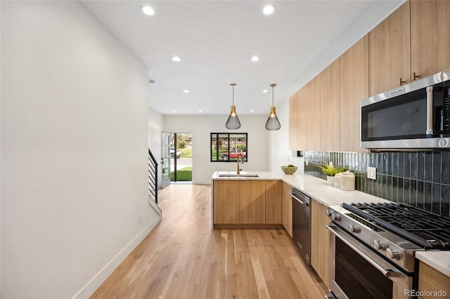 1735 Lowell Blvd, Denver, CO 80204 - kitchen featuring appliances with stainless steel finishes, modern cabinets, tasteful backsplash, a peninsula, and recessed lighting