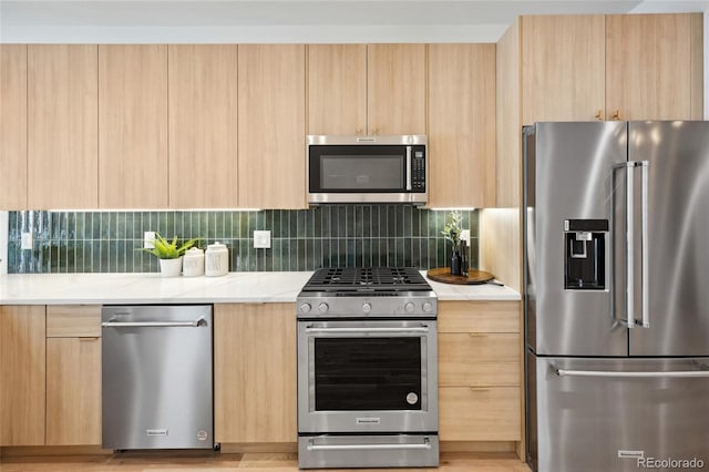 1735 Lowell Blvd, Denver, CO 80204 - kitchen with appliances with stainless steel finishes, light brown cabinets, and modern cabinets