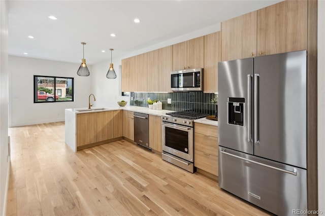 1735 Lowell Blvd, Denver, CO 80204 - kitchen featuring decorative backsplash, light brown cabinetry, light countertops, a peninsula, and stainless steel appliances