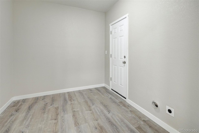 spare room with light wood finished floors and baseboards