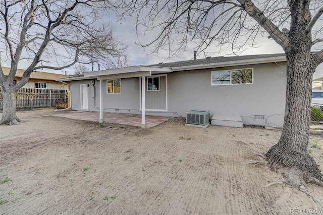 back of house featuring central air condition unit, stucco siding, crawl space, a patio area, and fence