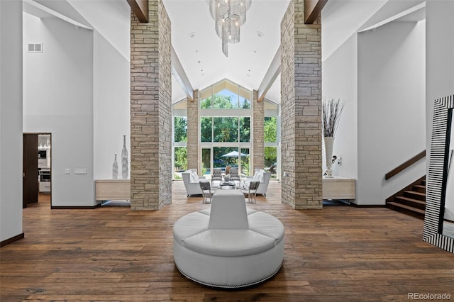 4766 S Fillmore Ct, Cherry Hills Village, CO 80113 - living area featuring high vaulted ceiling, decorative columns, wood finished floors, stairs, and baseboards
