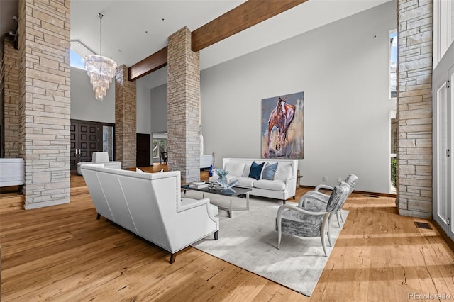 4766 S Fillmore Ct, Cherry Hills Village, CO 80113 - living area with decorative columns, a towering ceiling, wood-type flooring, and a chandelier