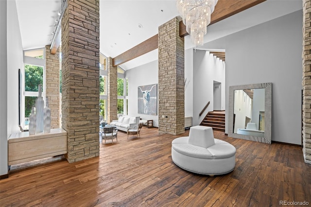 4766 S Fillmore Ct, Cherry Hills Village, CO 80113 - living area featuring decorative columns, high vaulted ceiling, wood-type flooring, a chandelier, and stairs