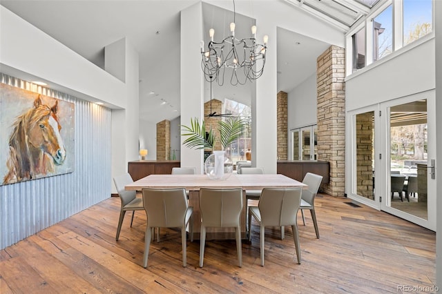 4766 S Fillmore Ct, Cherry Hills Village, CO 80113 - dining room with high vaulted ceiling, wood-type flooring, and a chandelier