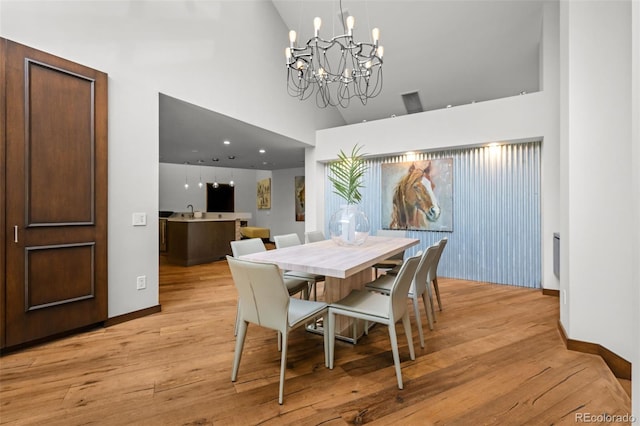4766 S Fillmore Ct, Cherry Hills Village, CO 80113 - dining space featuring a high ceiling, baseboards, light wood-style floors, and a chandelier