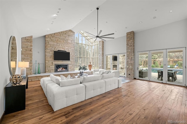 4766 S Fillmore Ct, Cherry Hills Village, CO 80113 - living room featuring high vaulted ceiling, a stone fireplace, hardwood / wood-style flooring, and a ceiling fan