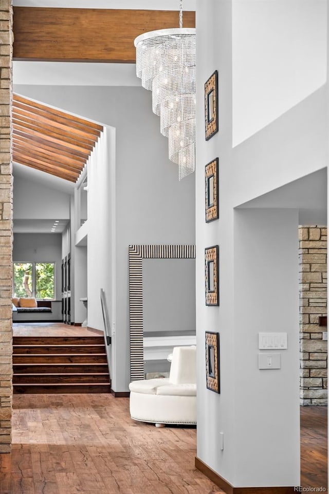 4766 S Fillmore Ct, Cherry Hills Village, CO 80113 - staircase with wood finished floors, baseboards, high vaulted ceiling, a chandelier, and beamed ceiling