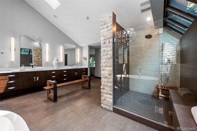 4766 S Fillmore Ct, Cherry Hills Village, CO 80113 - full bath with a skylight, vaulted ceiling, double vanity, and a shower stall