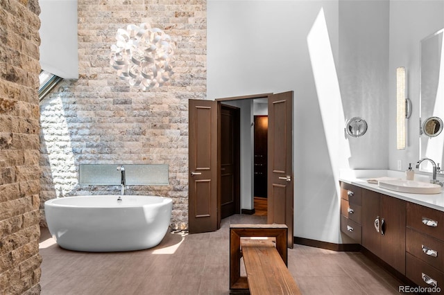 4766 S Fillmore Ct, Cherry Hills Village, CO 80113 - full bathroom with a high ceiling, a freestanding bath, vanity, and tile patterned floors