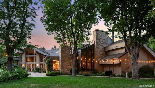 4766 S Fillmore Ct, Cherry Hills Village, CO 80113 - back of house with a chimney, a yard, and stone siding