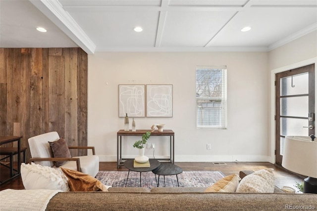 sitting room with hardwood / wood-style floors, coffered ceiling, wooden walls, and ornamental molding