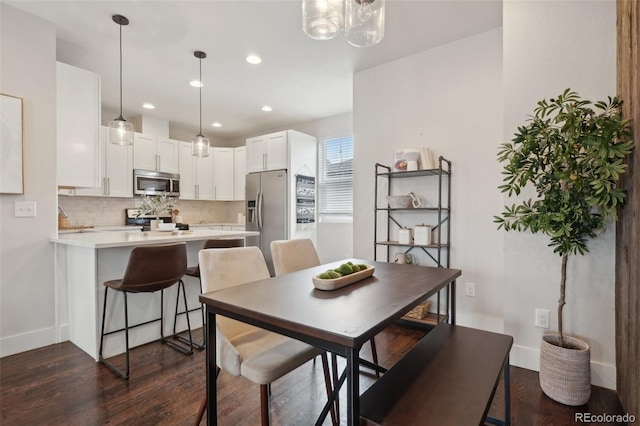 dining area featuring dark hardwood / wood-style flooring