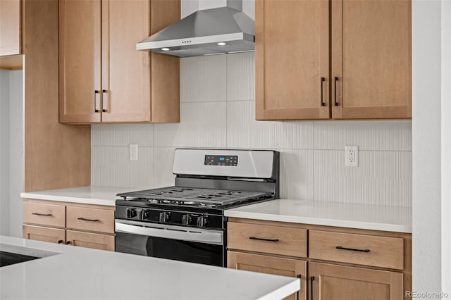 2736 W 68th Ave, Denver, CO 80221 - kitchen with wall chimney exhaust hood, stainless steel gas range, and light countertops