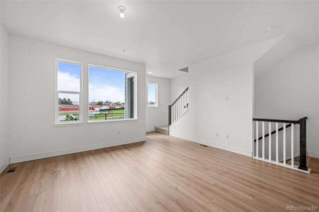 2736 W 68th Ave, Denver, CO 80221 - spare room featuring wood finished floors, baseboards, and stairs