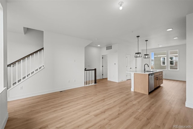 2736 W 68th Ave, Denver, CO 80221 - kitchen featuring stainless steel dishwasher, recessed lighting, light wood finished floors, an island with sink, and baseboards