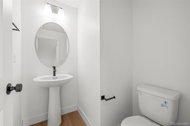 2736 W 68th Ave, Denver, CO 80221 - bathroom featuring wood finished floors, toilet, and baseboards