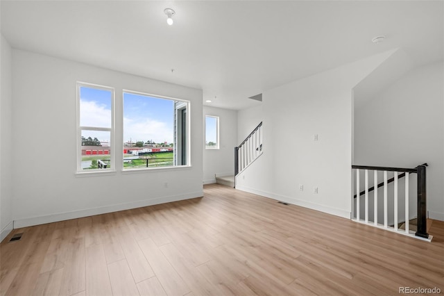 2736 W 68th Ave, Denver, CO 80221 - spare room with wood finished floors, baseboards, and stairway