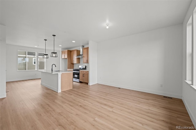 2736 W 68th Ave, Denver, CO 80221 - kitchen featuring stainless steel gas range, open floor plan, baseboards, recessed lighting, and light wood finished floors