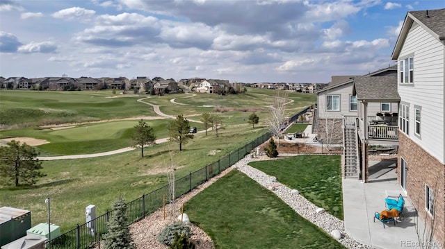 view of community with a residential view, view of golf course, a patio area, and a putting area