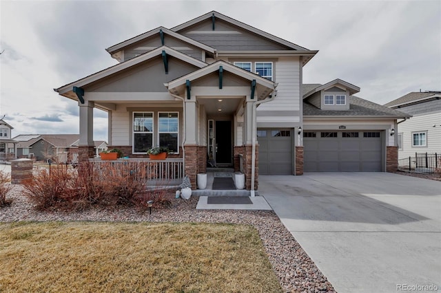 craftsman house with a porch, brick siding, concrete driveway, and a garage