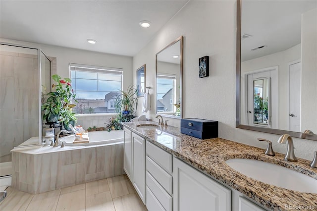 full bath featuring a garden tub, a shower stall, and double vanity