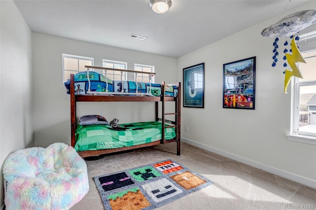 carpeted bedroom featuring baseboards