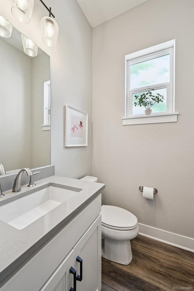 12320 W 51st Ave, Wheat Ridge, CO 80033 - half bathroom with wood finished floors and vanity
