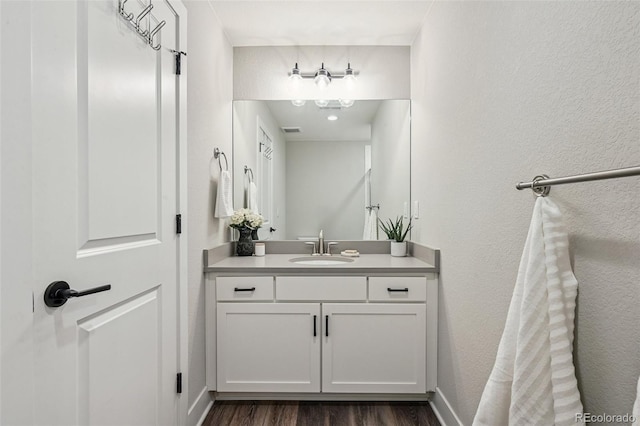 12320 W 51st Ave, Wheat Ridge, CO 80033 - bathroom featuring vanity, wood finished floors, and a textured wall