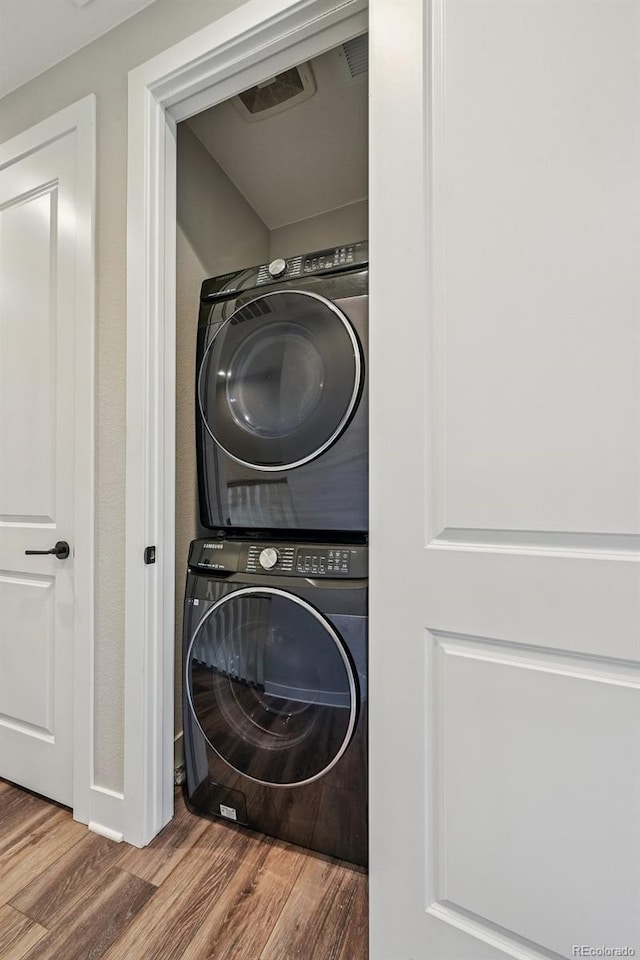 12320 W 51st Ave, Wheat Ridge, CO 80033 - washroom featuring stacked washer / dryer and wood finished floors
