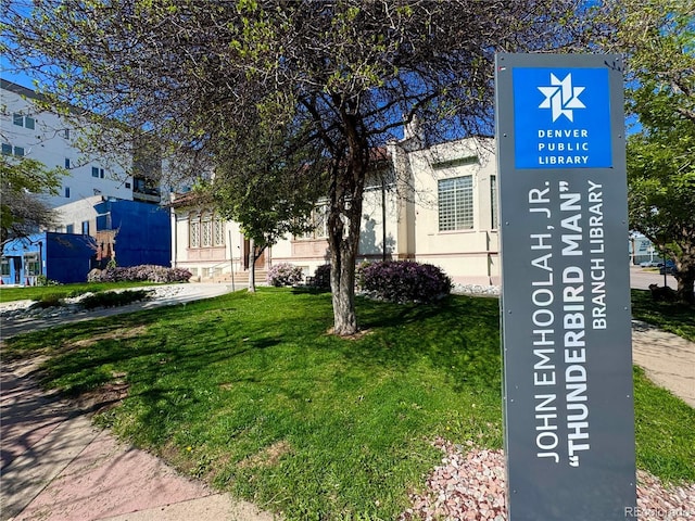 view of property's community with a lawn