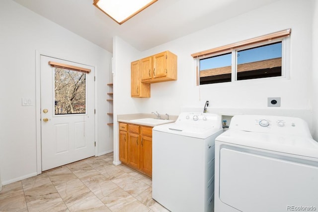 laundry area with independent washer and dryer, cabinets, and sink