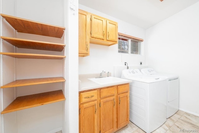 washroom with independent washer and dryer, cabinets, and sink