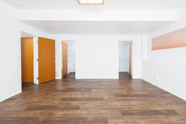 empty room with dark hardwood / wood-style flooring