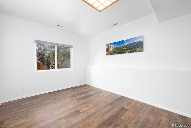 spare room featuring dark hardwood / wood-style flooring