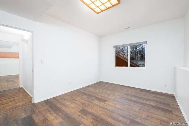 unfurnished room featuring dark hardwood / wood-style floors