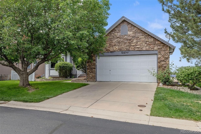 12277 W Chenango Dr, Morrison, CO 80465 - view of property hidden behind natural elements with stone siding, a front yard, concrete driveway, and an attached garage