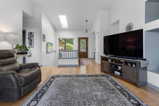 12277 W Chenango Dr, Morrison, CO 80465 - living area featuring light wood finished floors and a skylight